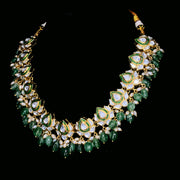 Polki artistry with green stone and pearl embellishments. Necklace